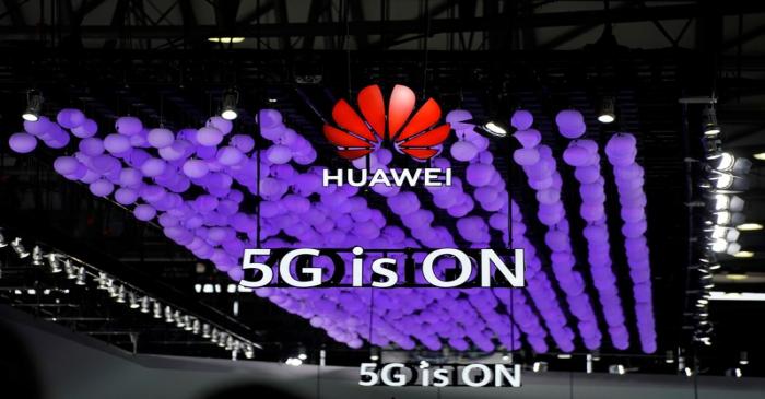 A Huawei logo and a 5G sign are pictured at Mobile World Congress (MWC) in Shanghai