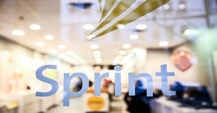 A Sprint sign is seen on top of a Sprint retail store in New York