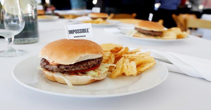 The completed plant-based hamburger is displayed during a media tour of Impossible Foods labs