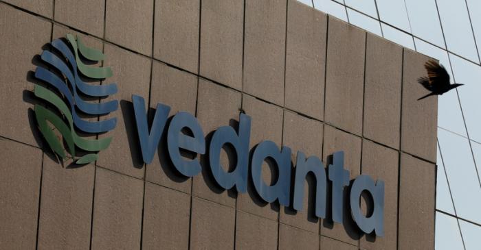 FILE PHOTO: A bird flies past the logo of Vedanta installed on the facade of its headquarters