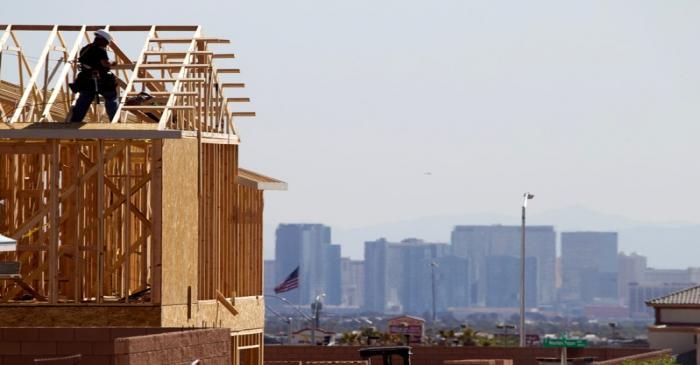 FILE PHOTO: A carpenter works on a new home at a residential construction site in the west side