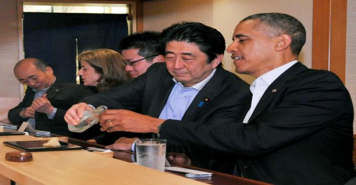 FILE PHOTO : Japanese Prime Minister Shinzo Abe pours sake for U.S. President Barack Obama as