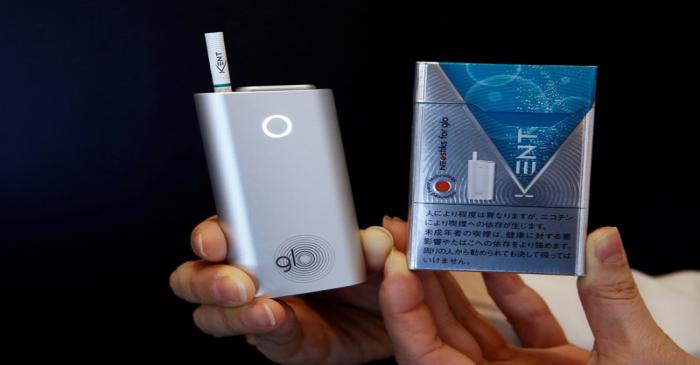 FILE PHOTO: A promoter shows British American Tobacco's new tobacco heating system device 'glo'