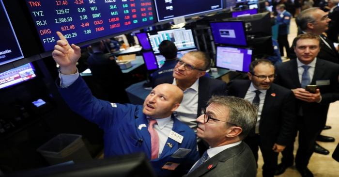 CEO of Kaleyra, Dario Calogero, looks up at a board before the company's IPO above the floor of