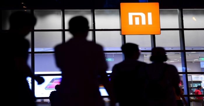 People walk past a Xiaomi store in Shenyang