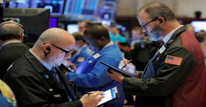 Traders work on the floor of the New York Stock Exchange shortly after the opening bell in New