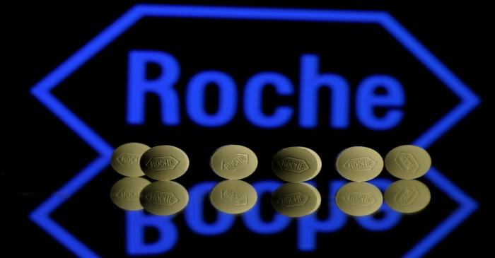 FILE PHOTO: Roche tablets are seen positioned in front of a displayed Roche logo in this photo