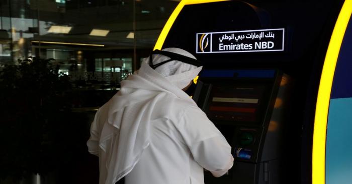 FILE PHOTO: A customer uses an ATM machine at the Emirates NBD head office in Duba