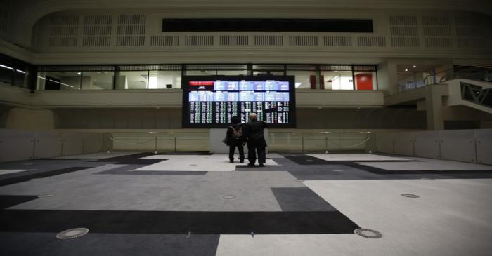 Visitors looks at an electronic board showing the Japan's Nikkei average at the Tokyo Stock