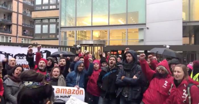 Demonstrators take part in a protest outside Amazon's French headquarters in Clichy