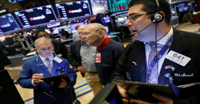 Traders work on the floor at the NYSE in New York