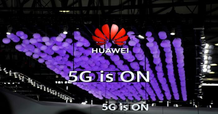 FILE PHOTO: A Huawei logo and a 5G sign are pictured at Mobile World Congress (MWC) in Shanghai