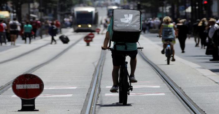 FILE PHOTO: A food delivery cyclist carries a Deliveroo bag in Nice