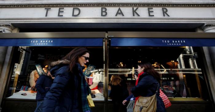 Shoppers walk past a Ted Baker store on Regents Street in London