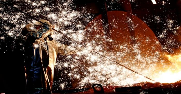 FILE PHOTO: A steel worker of Germany's industrial conglomerate ThyssenKrupp AG stands a mid of