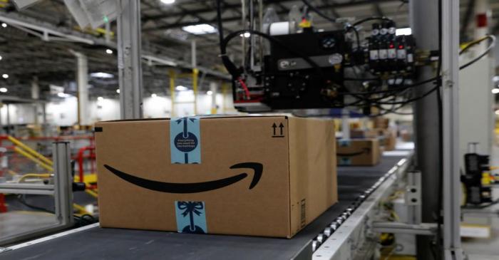 Packaged merchandise on a conveyer belt after being labeled for shipping is seen at the Amazon