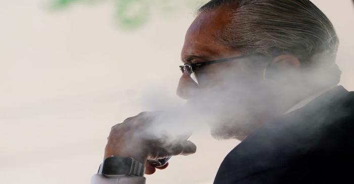 FILE PHOTO: A man uses a vaping product in the Manhattan borough of New York