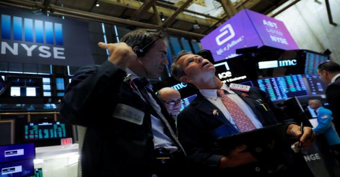 Traders work on the trading floor at the New York Stock Exchange (NYSE) at the opening of the