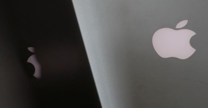 Apple company logos are seen as two MacBooks stand next to each other in an office in Vienna