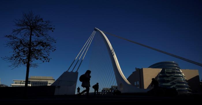 Commuters walk into work in the morning in the financial district of Dublin