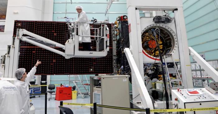 FILE PHOTO: Technicians work on the Inmarsat S-Band/Hellas-Sat 3 satellite in the clean room