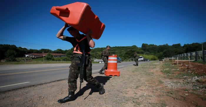 Soldiers of the Brazilian army patrol near the Spa de Vinho hotel, which will host the next
