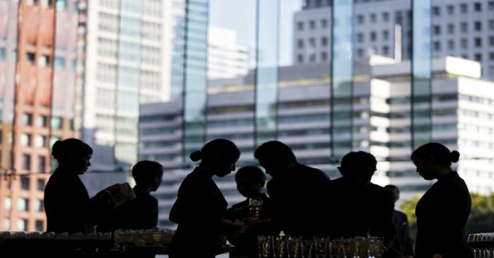 Butlers prepare for drinks inside a banqueting hall at a hotel in Tokyo