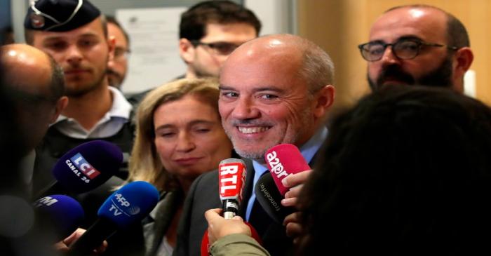 Orange chief executive Stephane Richard speaks to reporters inside the courthouse in Paris