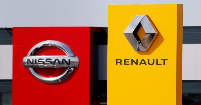 The logos of car manufacturers Renault and Nissan are seen in front of dealerships of the