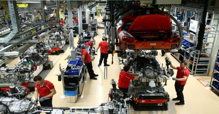 FILE PHOTO: Employees of German car manufacturer Porsche assemble sports cars at the Porsche