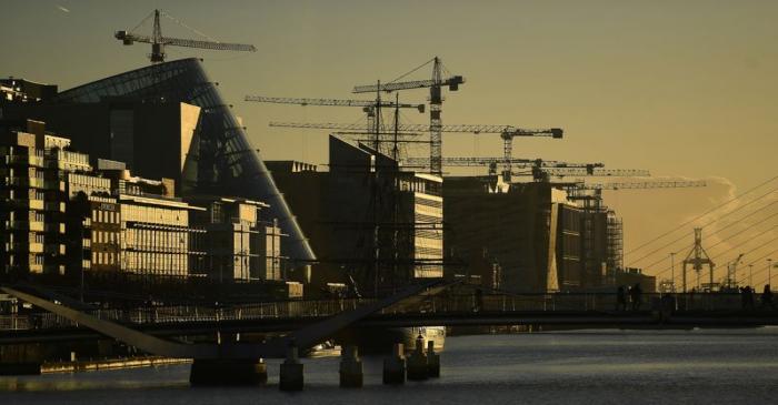 FILE PHOTO: Construction cranes are seen at sunrise in the financial district of Dublin