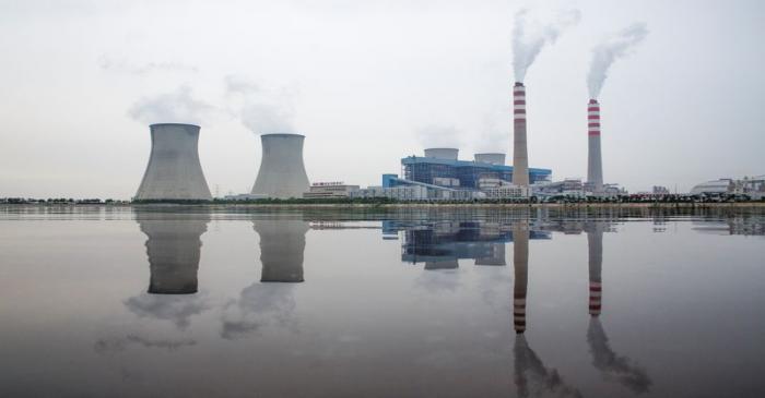 A power station of the State Development & Investment Corporation (SDIC) is reflected in a lake