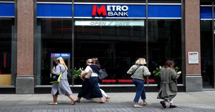FILE PHOTO: People walk past a Metro Bank in London, Britain