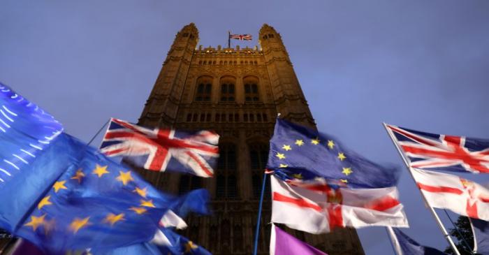 Flags flutter outside the Houses of Parliament in London