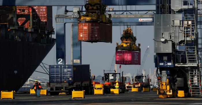 FILE PHOTO: Shipping containers are loaded onto a ship at Yusen Terminals at the Port of Los