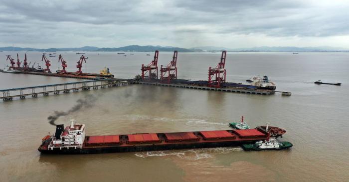 Bulk carrier leaves the Ningbo Zhoushan port with the assistance of tugboats in Zhejiang