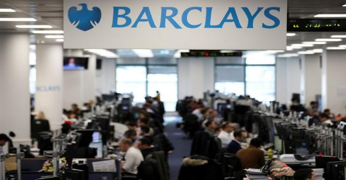 Traders work on the trading floor of Barclays Bank at Canary Wharf in London