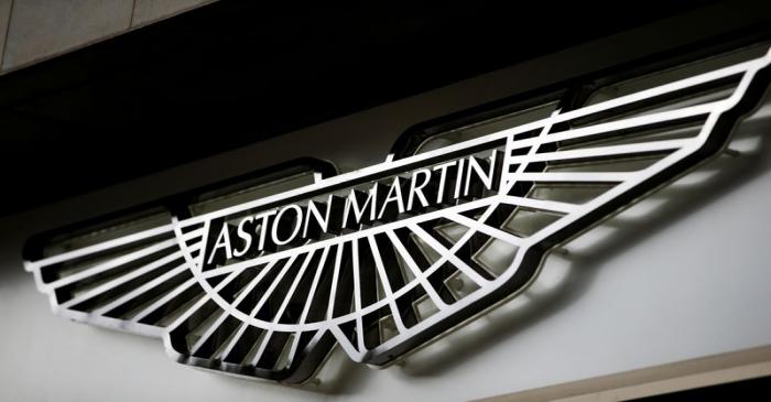 An Aston Martin logo is seen on the outside of a dealership in central London