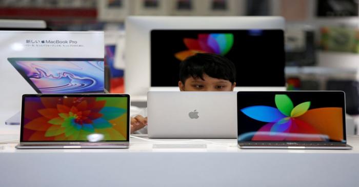FILE PHOTO: A boy tries to use an Apple laptop at a computer shop in Tokyo