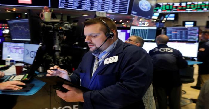 Traders work on the floor of the New York Stock Exchange shortly after the opening bell in New