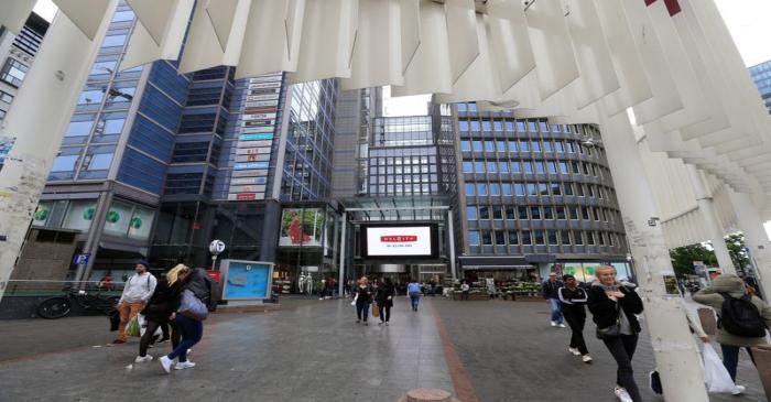 People gather next to the Oslo City shopping center in Oslo