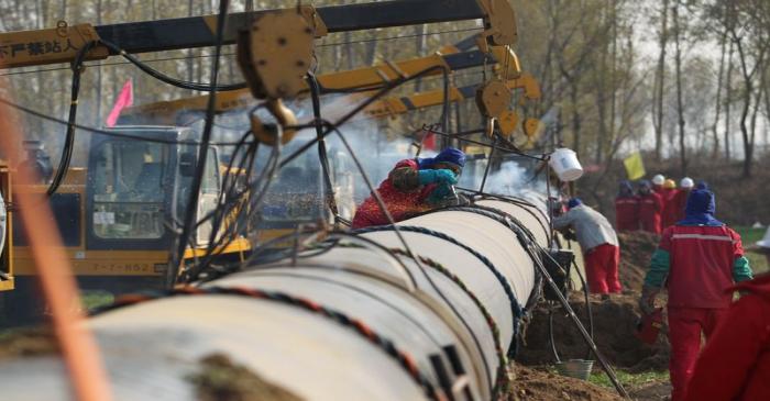 Workers lay pipelines for China National Petroleum Corp (CNPC)'s Shaanxi-Beijing natural gas