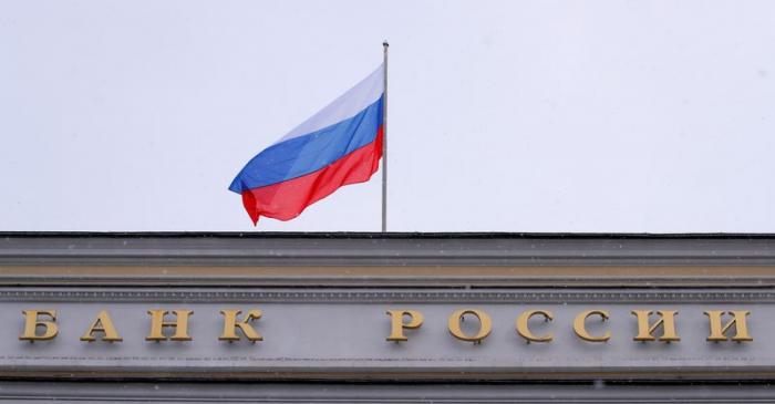 A Russian flag flies over Russian Central Bank headquarters in Moscow