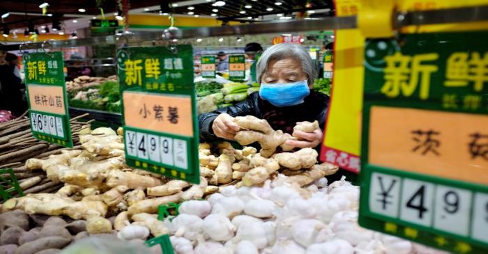 FILE PHOTO: A resident selects ginger at a supermarket in Beijing