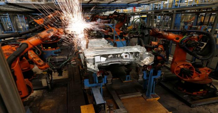 A welding robot creates sparks during the body shell production of a Ford Fiesta at the Ford