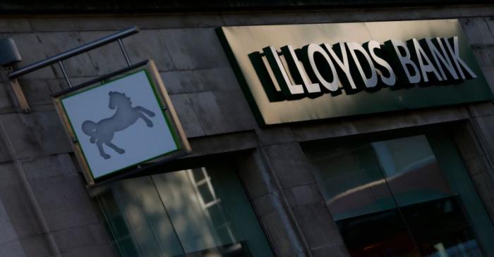 Signs are seen outside a branch of Lloyds Bank in central London