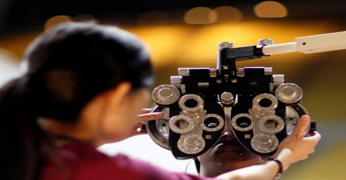 FILE PHOTO: A patient undergoes an eye exam at the Remote Area Medical health clinic in