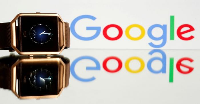FILE PHOTO: FILE PHOTO: Fitbit Blaze watch is seen in front of a displayed Google logo in this
