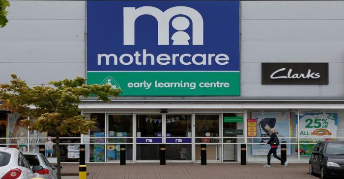 People walk past a Mothercare store in Altricham