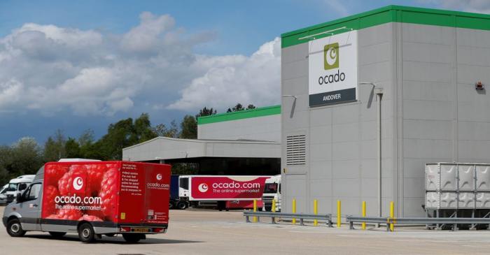 FILE PHOTO: A delivery van leaves the dispatch area of the Ocado CFC (Customer Fulfilment